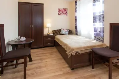 a bedroom with a bed and a table and chairs at Vanilla Apartments - 3 spacious apartments 5min to Main Square in Kraków