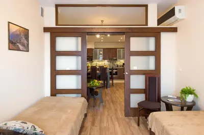a room with two beds and a mirror on the wall at Vanilla Apartments - 3 spacious apartments 5min to Main Square in Kraków