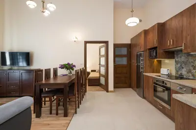 a kitchen and dining room with a table and chairs at Vanilla Apartments - 3 spacious apartments 5min to Main Square in Kraków