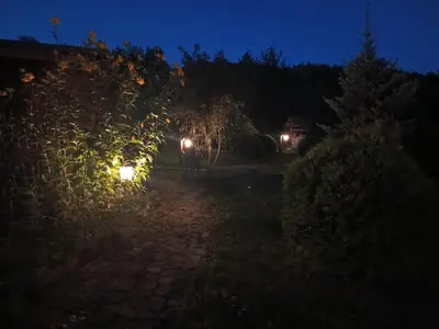 a night view of a garden with lights at Dom w Chomranicach-domek grillowy in Chomranice