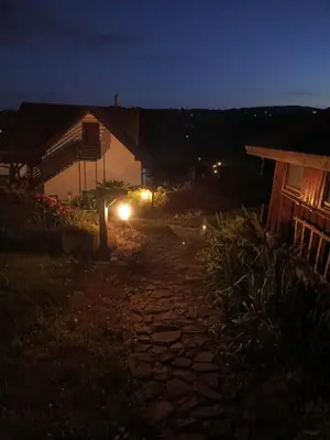 a night view of a stone walkway next to a building at Dom w Chomranicach-domek grillowy in Chomranice