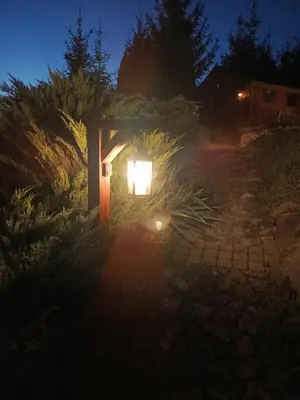 a light in the middle of a garden at night at Dom w Chomranicach-domek grillowy in Chomranice
