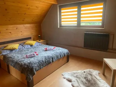 a wooden door in a room with a window at Chatka Puchatka in Tenczyn