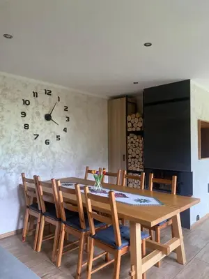 a attic room with a table and a window at Chatka Puchatka in Tenczyn