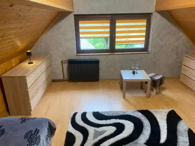 a living room with a couch and a table at Chatka Puchatka in Tenczyn