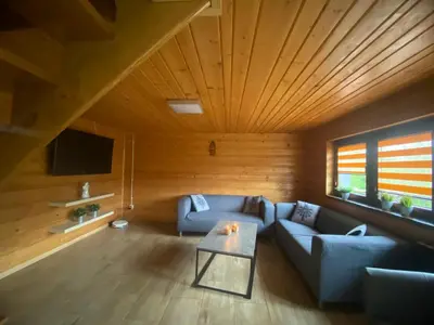 a living room with a couch and a table at Chatka Puchatka in Tenczyn