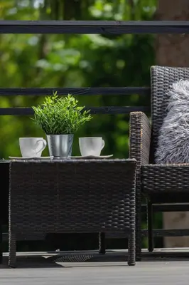 a patio table with two cups and a potted plant at Spacious Apartment in Wieliczka with AC & Parking in Wieliczka