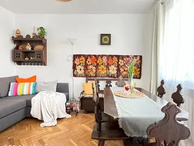 a living room with a table and a couch at Cozy Apartment 10 minutes to Wawel Castle in Kraków