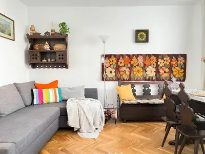 a living room with a gray couch and a table at Cozy Apartment 10 minutes to Wawel Castle in Kraków