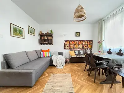 a living room with a couch and a table at Cozy Apartment 10 minutes to Wawel Castle in Kraków