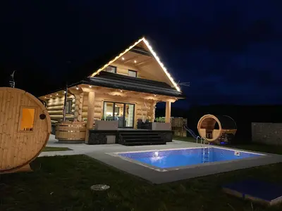 a house with a swimming pool at night at Chata pod Groniem in Skawica