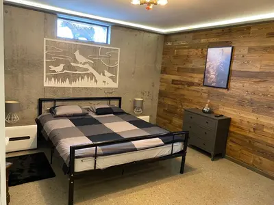 a bedroom with a bed and a painting on the wall at Chata pod Groniem in Skawica
