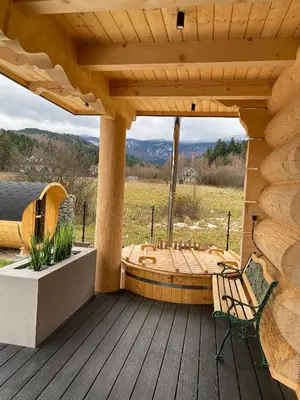 a wooden porch with a bench on a deck at Chata pod Groniem in Skawica