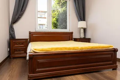 a bedroom with a bed with a window at Apartament Kraków - Cracow Apartment 70m2 in Kraków