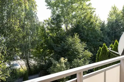 a balcony with trees and a white fence at Apartament Kraków - Cracow Apartment 70m2 in Kraków