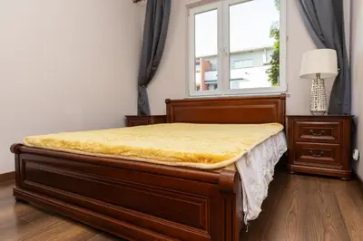a bed in a room with a window at Apartament Kraków - Cracow Apartment 70m2 in Kraków