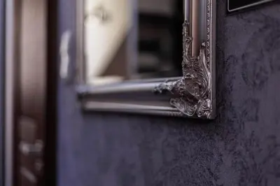 a mirror on the side of a door at Krupnicza 10 by Homeprime in Kraków