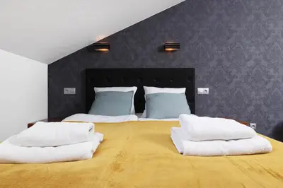 a bedroom with a large bed with two white towels on it at Krupnicza 10 by Homeprime in Kraków