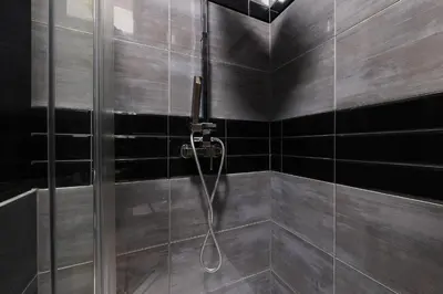a shower with a glass door in a bathroom at Krupnicza 10 by Homeprime in Kraków