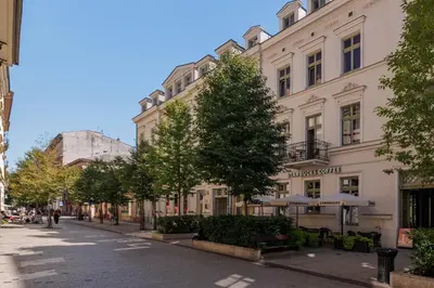 a street in a city with buildings and trees at Krupnicza 10 by Homeprime in Kraków