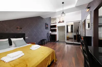 a bedroom with a large yellow bed with two white towels at Krupnicza 10 by Homeprime in Kraków