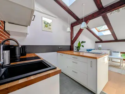 a kitchen with white cabinets and a stove top oven at Dwernickiego 7 by Homeprime in Kraków