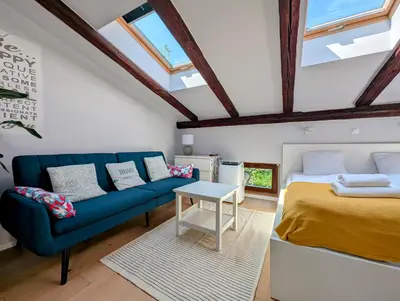 a bedroom with a blue couch and a bed at Dwernickiego 7 by Homeprime in Kraków