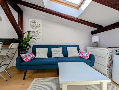 a living room with a blue couch and a table at Dwernickiego 7 by Homeprime in Kraków