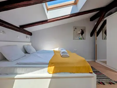 a bedroom with a bed with a yellow blanket on it at Dwernickiego 7 by Homeprime in Kraków