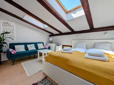 a bedroom with a large bed and a blue couch at Dwernickiego 7 by Homeprime in Kraków