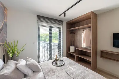 a living room with a couch and a window at Balice Apartamenty Premium - by Upstairs in Cholerzyn