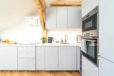 a white kitchen with white cabinets and appliances at ShortStayPoland Siemieńskiego C5 in Kraków