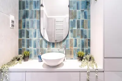 a bathroom with a sink and a mirror at ShortStayPoland Siemieńskiego C5 in Kraków