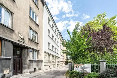 an empty street in front of a building at ShortStayPoland Siemieńskiego C5 in Kraków