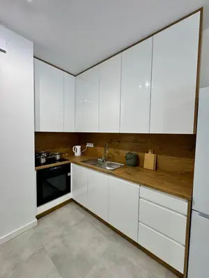 a kitchen with white cabinets and a sink at Apartamenty RS Kazimierza Wielka in Kazimierza Wielka