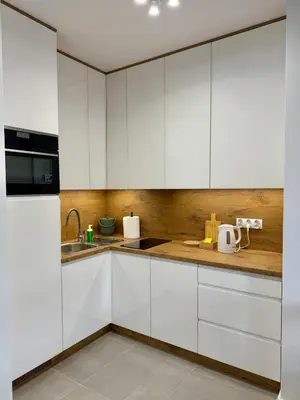 a kitchen with white cabinets and a sink at Apartamenty RS Kazimierza Wielka in Kazimierza Wielka