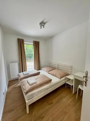 a bedroom with a large bed and a window at Apartamenty RS Kazimierza Wielka in Kazimierza Wielka