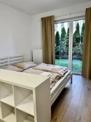 a white bed in a room with a window at Apartamenty RS Kazimierza Wielka in Kazimierza Wielka