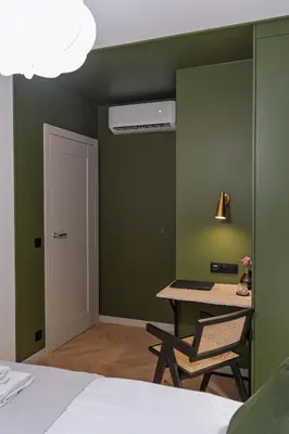 a bedroom with a bed and a table and a ceiling fan at Apartment next to Wawel, Premium Stay in Central Krakow by Koletek 3 in Kraków