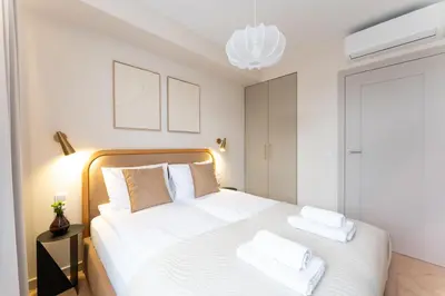 a bedroom with a bed with white sheets and pillows at Apartment next to Wawel, Premium Stay in Central Krakow by Koletek 3 in Kraków