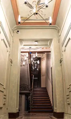 a hallway with stairs and a ceiling with a chandelier at Apartment next to Wawel, Premium Stay in Central Krakow by Koletek 3 in Kraków
