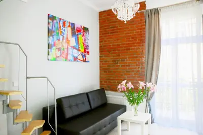 a kitchen counter with a sink and a microwave at Elegant Studio Bonerowska in Kraków
