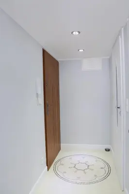 a white kitchen with a spiral staircase and a chandelier at Elegant Studio Bonerowska in Kraków