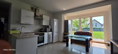 a kitchen with a counter and a table and a window at Fabryka Snów NC in Niepołomice