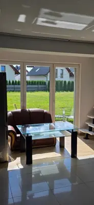 a living room with a couch and a glass table at Fabryka Snów NC in Niepołomice