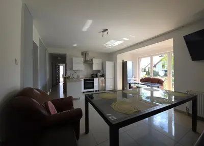 a kitchen and living room with a glass table at Fabryka Snów NC in Niepołomice