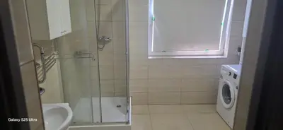 a bathroom with a shower and a washing machine at Fabryka Snów NC in Niepołomice