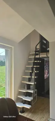 a spiral staircase in the corner of a room at Fabryka Snów NC in Niepołomice