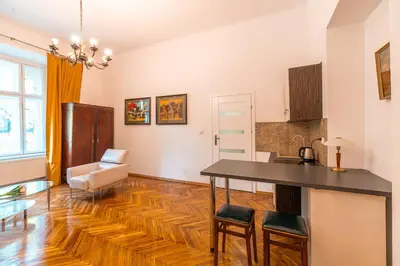 a kitchen and living room with a table and chairs at Straszewskiego view in Kraków