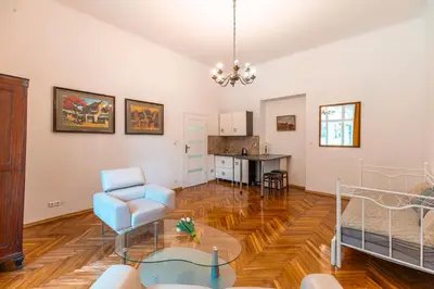 a living room with a chair and a table at Straszewskiego view in Kraków